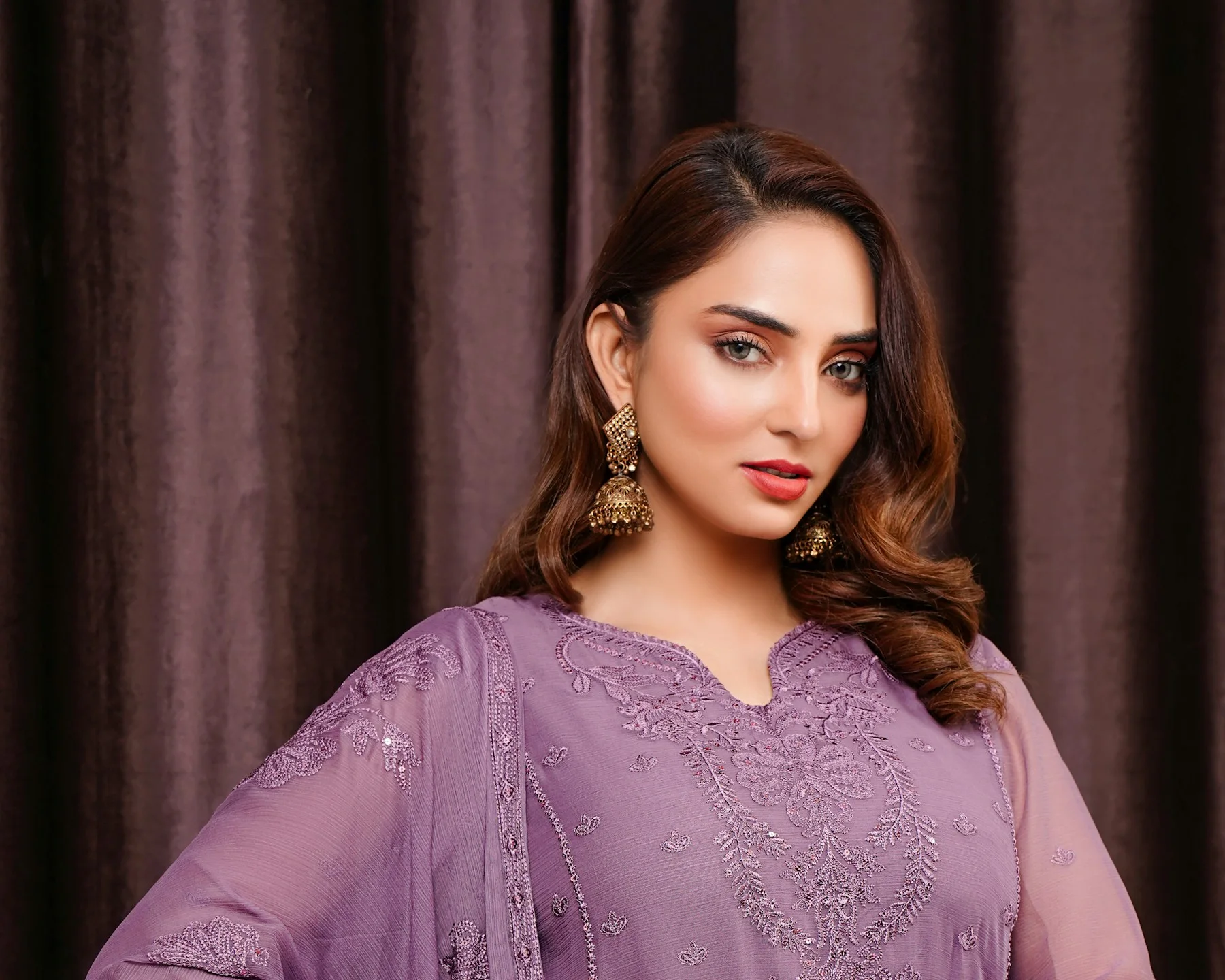 Woman in a lilac embroidered shalwar kameez with a chiffon dupatta